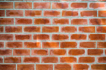 Orange bricks block on cement wall