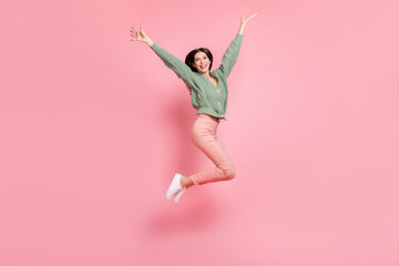 Wall Mural - Full length body size view of attractive cheerful girl jumping having fun isolated over pink pastel color background