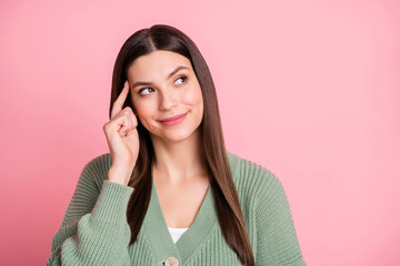 Wall Mural - Photo of pretty optimistic girl look empty space finger head wear sweater isolated on pink color background