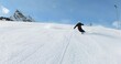 Professional skiing, beautiful short ski turns on a long and steep ski slope in the mountains of tyrol. Skiing sporty ski turns with style and elegance on a fresh groomed ski slope in a winter resort.