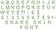 Snake scales font. Alphabet letters ABCDEFGHIJKLMNOPQRSTUVWXYZ and digits 1234567890 set cut out of paper on the background of a green snake skin with large scales.
