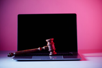 Wooden gavel on laptop. Online auction concept