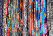Colourful Display of Patterned Materials Hanging on Outdoor Market Stall