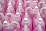 Fototapeta Lawenda - lot of Professional Liquid Wash Soap Refill light pink color chemicals in plastic bottles cans in the warehouse store. Heap Antibacterial Hand Soap in plastic canisters with white plastic cork cap.