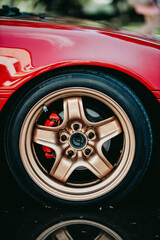 Wall Mural - Closeup of a wheel of a red glossy sports car