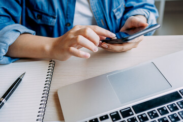 Canvas Print - close up view of hands women using smartphone while working at home, lifestyle female freelancer office, chatting online via application mobile phone.