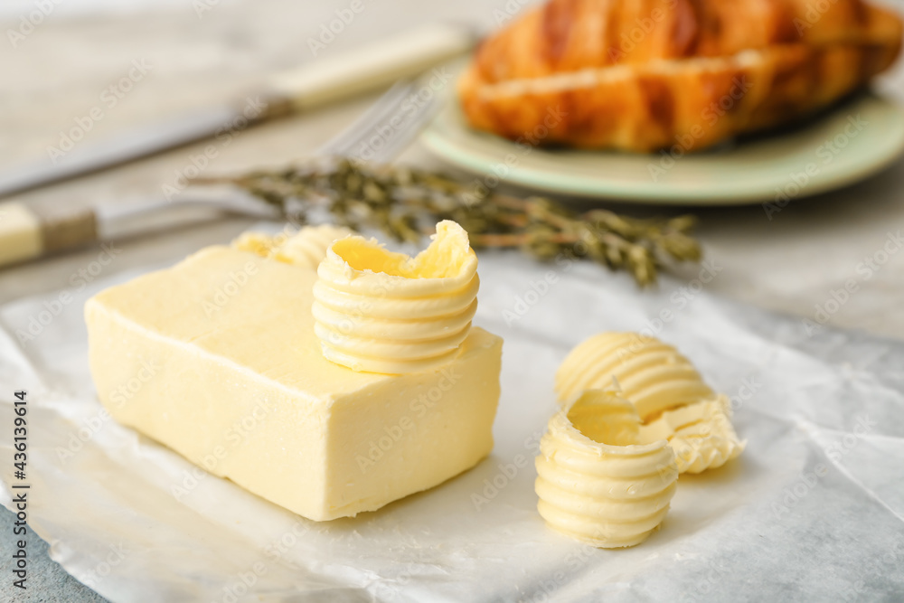 Fresh butter and rosemary on light background