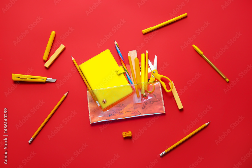 Pencil case and stationery on color background