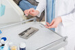 © LIGHTFIELD STUDIOS - cropped view of female dentist hands holding metal tools above metal tray on table in dental clinic.