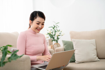 young beautiful woman using a laptop computer at home