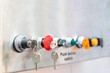 © Surasak - Key switch and Various color push button switch on off for start stop and emergency switch for machine system control install on control panel board copy space