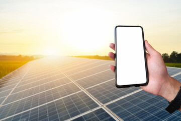 Mockup Mobile phone holding in hand with blurred solar roof background, concept for using smart devices with solar system at home, at work, on application and in daily life.