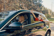 © gstockstudio - Happy family with little boy having fun and smiling while riding in the car