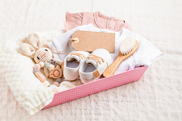 Wall Mural - Gift basket with gender neutral baby garment and accessories. Care box of organic newborn cotton clothes