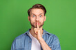 Photo of shocked amazed surprised man cover mouth with finger silence speechless isolated on green color background