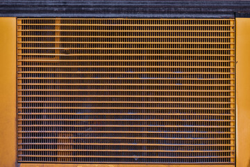 Canvas Print - Closeup of yellow metal radiator texture