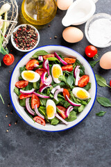 Wall Mural - Spring salad. Salad with spinach leaves, tomatoes and boiled egg. Proper nutrition. The taste of summer. Raw ingredients in a snack. Seasonal vegetables and herbs. Healthy snack