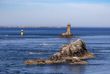 Rocks In Sea And Lighthouse