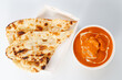 © papzi - Indian curry Butter Chicken and nan by delivery in Take away blow.