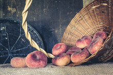Peaches In A Basket On An Old Background