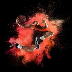 Wall Mural - One young sportsman basketball player in explosion of colored neon powder isolated on dark background