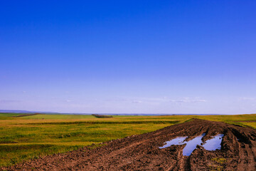 Puddles on a country road on a sunny day