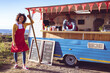 © Wavebreak Media - Portrait of smiling diverse couple in food truck by seaside