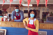 © Wavebreak Media - Portrait of diverse couple wearing face masks in food truck