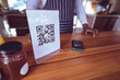 © Wavebreak Media - Midsection of african american man in food truck with qr code menu on worktop