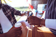 © Wavebreak Media - Midsection of african american man in food truck taking smartphone payment holding terminal