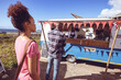 © Wavebreak Media - Smiling african american man in food truck taking order from male customer