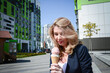 © bisonov - Beautiful young caucasian woman portrait eating ice cream at the city street on a summer