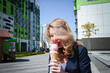 © bisonov - Beautiful young caucasian woman portrait eating ice cream at the city street on a summer