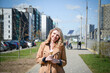 © bisonov - Beautiful young caucasian woman portrait eating ice cream at the city street on a summer