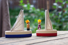 Two Handcrafted Wooden Sailing Boats With Small Figures Of The King And Queen With Felt Crowns