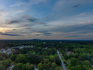Wall Mural - a breathtaking aerial panoramic shot of a sunset over Powder Springs Georgia with miles of vast green trees and homes with powerful clouds