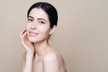 beautiful young caucasian woman with clean fresh skin on beige background, face care, facial treatme