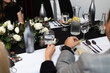 Guests sit at a fancy table for a black and white dinner event