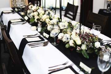 Place setup for formal black and white social dinner