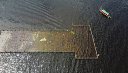 Aerial view of a flooded pier in the Port of Manaus during the rise of Negro River waters due to heavy rains and La Nina phenomenon, state of Amazonas, Brazil.