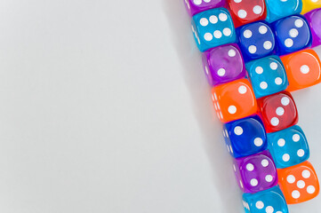 Wall Mural - Top view of a group of colorful transparent dice on white background for a copy space