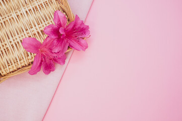 Pink lilies on a straw texture isolated on a pink background