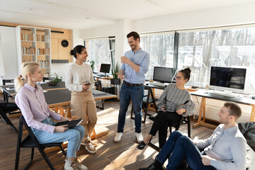 Canvas Print - Happy diverse colleagues employees team having fun at meeting, sitting in circle, workers interns sharing ideas or funny news, involved in briefing, pleasant conversation, discussing project strategy