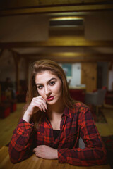 Canvas Print - Vertical shot of a young attractive female posing in a casual outfit