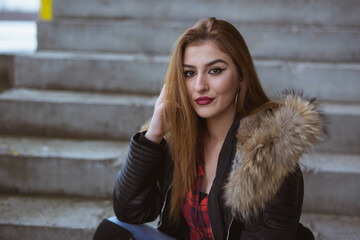 Sticker - Closeup shot of a white Caucasian woman wearing a black jacket and posing for a picture