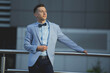 Young male model posing in a light blue suit and a bow tie