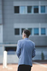 Wall Mural - Young elegant Caucasian man wearing an expensive blue suit at an event