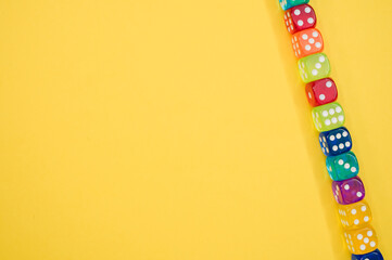 Wall Mural - Dice in a row isolated on a yellobackground