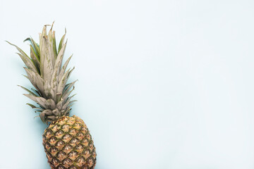 Wall Mural - whole ripe pineapple on a light background. Top view, flat lay