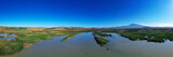 Fototapeta Nowy Jork - 180 degrees aerial photo of the Oasis of Ponte Barca a protected area in the heart of Paternò in Sicily. Wetland that attracts numerous waterfowl. Nesting place of the Sultan chicken. Etna view.
